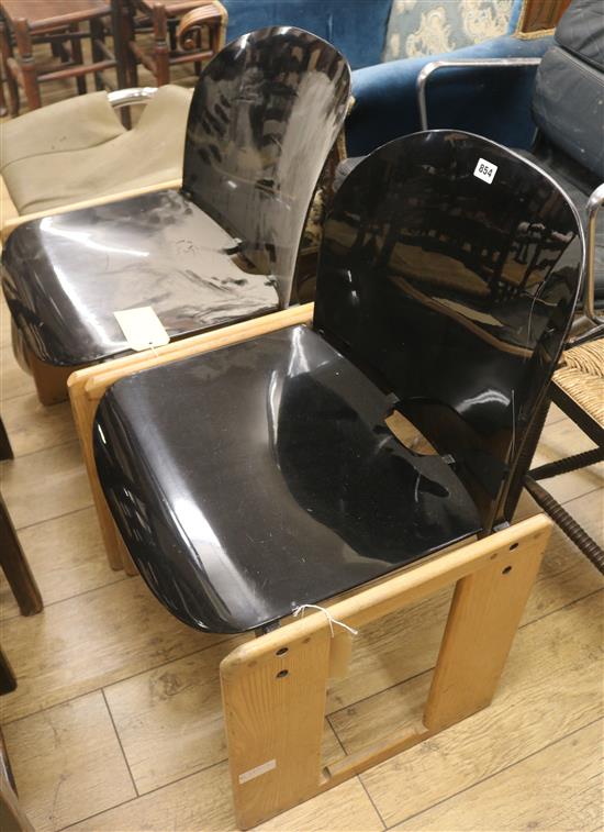 A pair of stylish modern black perspex chairs